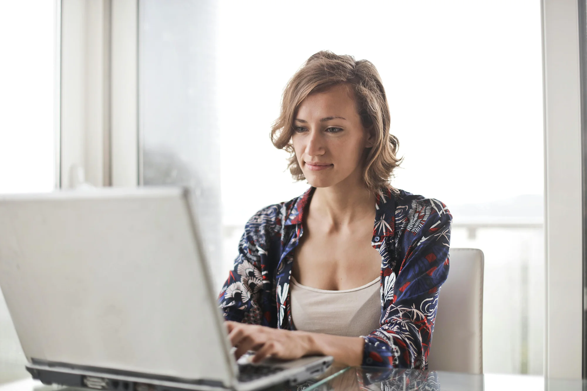 Older woman studying online at a computer